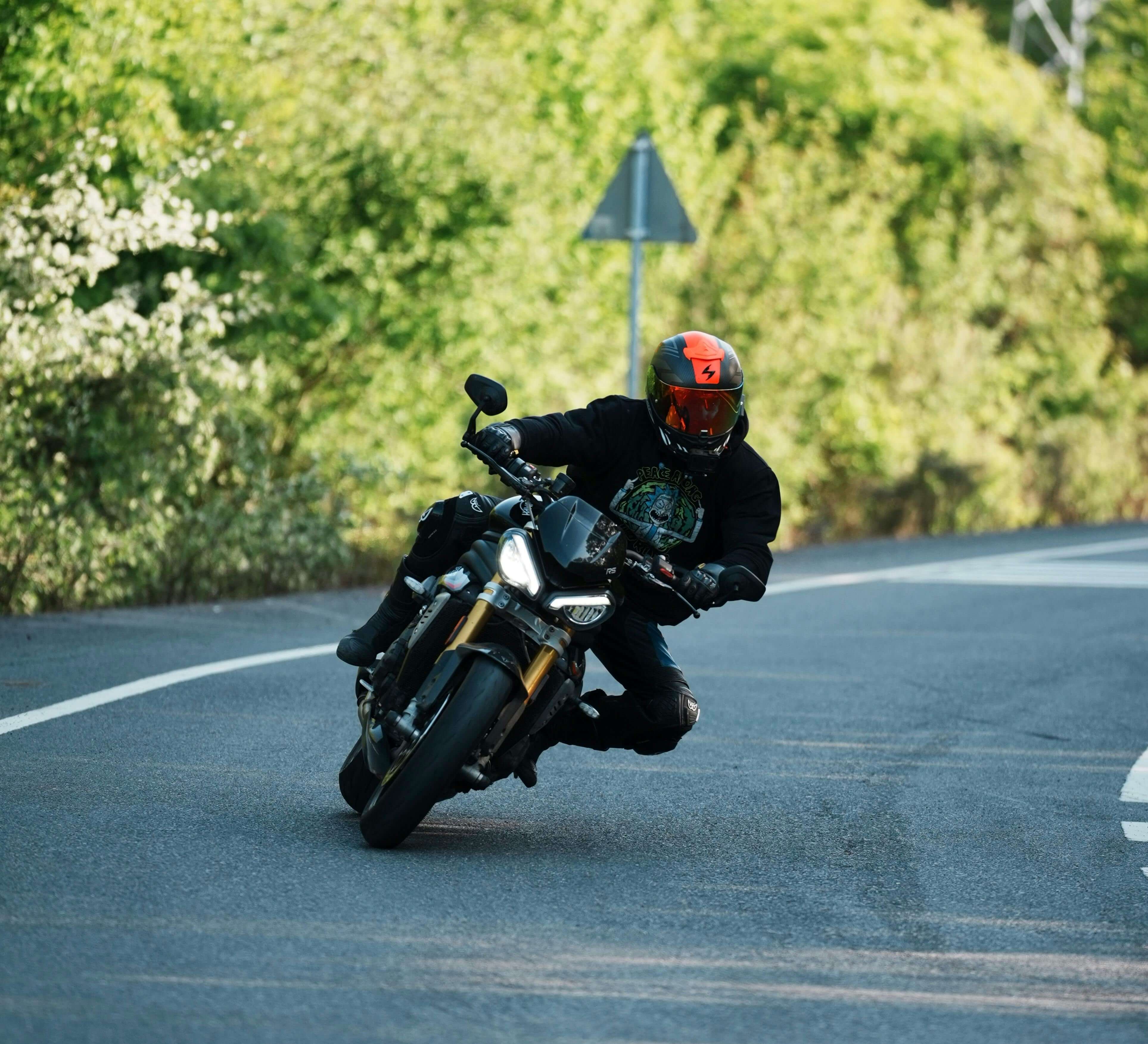 Motorcycle leaning into a curve on a road