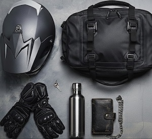 Motorcyclist on their bike with snow in the background.